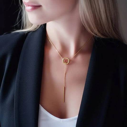 Necklace with a circular pendant worn by a person