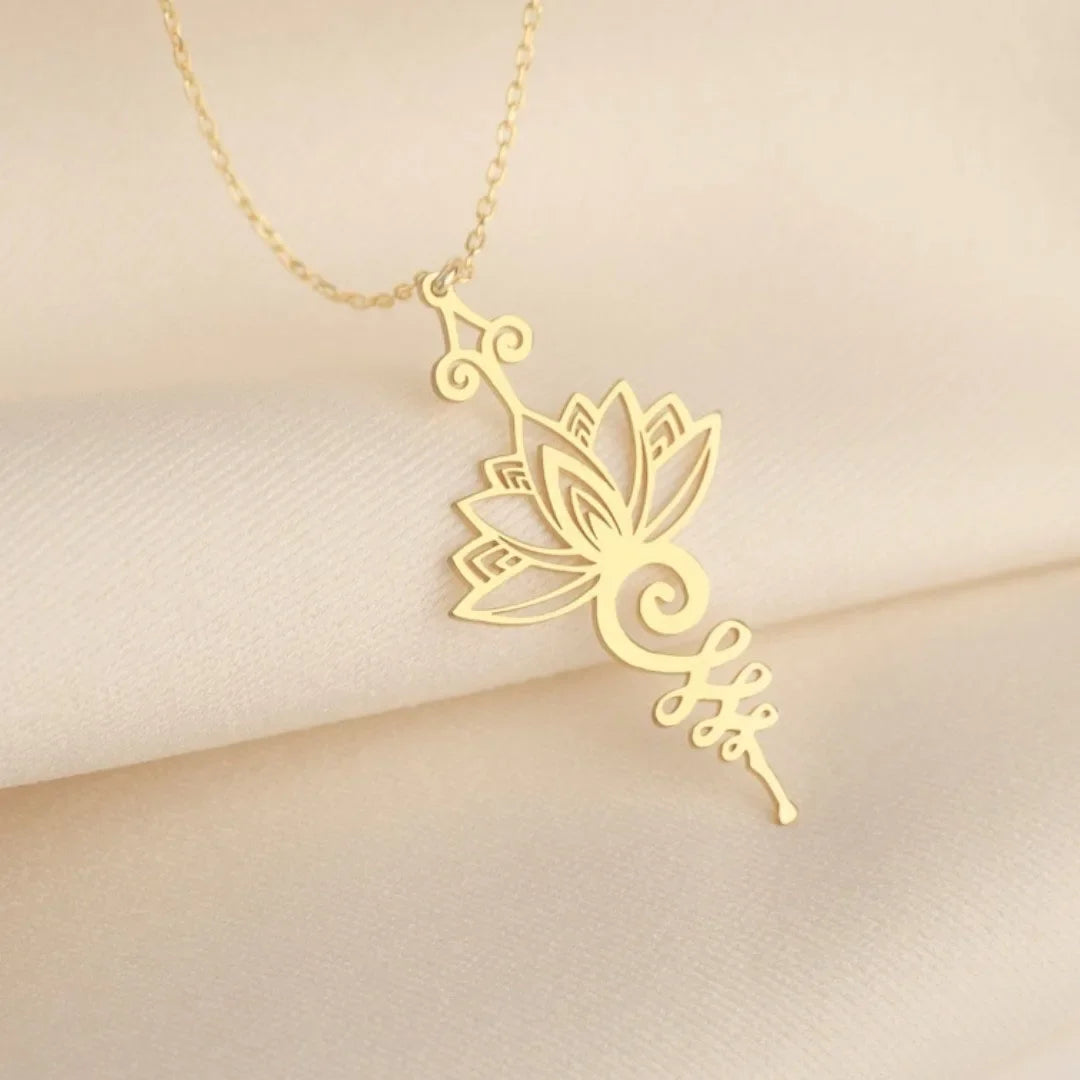 Gold lotus flower necklace on a beige background